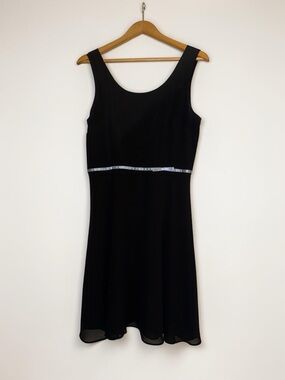 Sleeveless dress with empire waist and minimalist bow detail